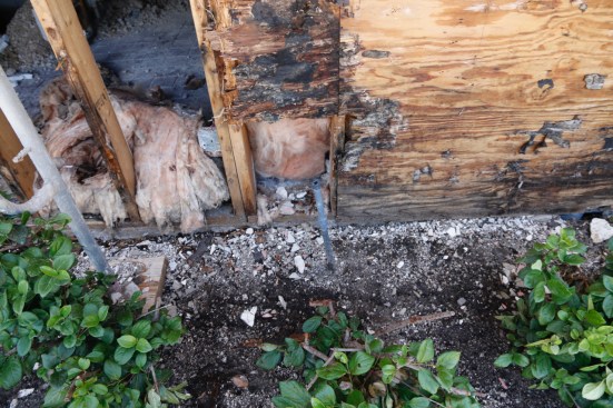 See that grey sprinkler pipe in the middle of the picture? That was pointed at the wall and gave it a good soaking a few days each week. The double layer of #15 felt paper got wet and never had time (or airflow) to dry; that constant wetness led to the sheathing underneath getting soaked. Remember that in modern buildings with insulation there is no airflow inside the wall to promote drying. This wall is only 10 to 15 years old but was totally rotted.