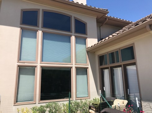 In this before photo, some rot is visible at the brick mold around the windows, but the stucco looks normal, with no signs of rot or failure.