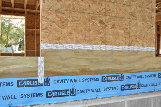 The blue peel & stick in this picture is the base wall flashing. It will protect that vulnerable joint between foundation and framing from both water and air coming in. (Both are big trouble for a wood-framed house.)