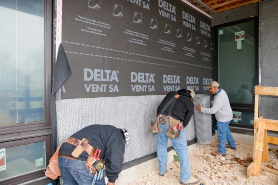 Next, the stucco metal weep goes over the top. Notice that we detailed the slab foundation on this project with a recess, or reglet, to make the stucco flush with the edge of the slab. This was designed by architect Nick Deaver, AIA.