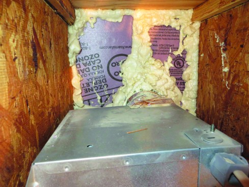 To fix the problem, the author’s crew sealed up the joist bay with rigid foam board and canned foam sealant.