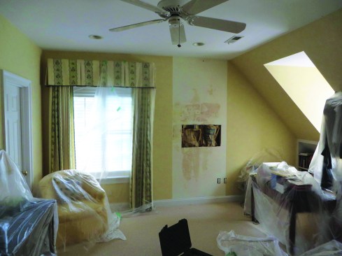 This wall became damp when moisture was driven in from a stone exterior by sunshine and condensed on the back of the vinyl wallpaper.