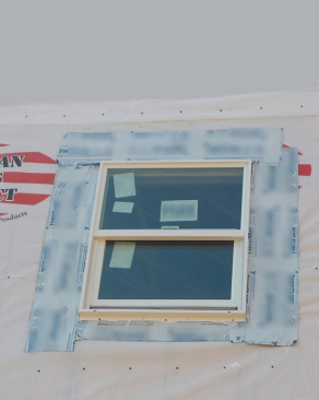 This window shows what not to do when using any kind of housewrap around a window. It is an example of the old system of cutting an “X” and folding in the wrap. Notice the self-adhered flashing tape is not shingle-lapped at the head and isn’t cut to the right lengths.
