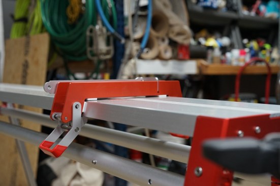 Sliding stop on miter saw wing for repetitive cuts.