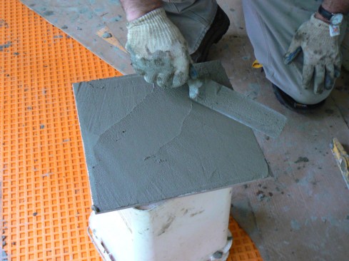 To ensure enough coverage over the waffled surface of the Schluter-Ditra membrane, the author also back-buttered every tile.