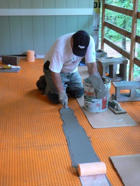 The author taped the membrane seams with 5-inch Schluter Kerdi-Band embedded in unmodified thinset. The process of taping these seams is a lot like that of taping drywall seams and can be done with the same tools.