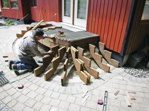 To provide plenty of support for the fiberglass grating substrate, the deck joists were installed 12 inches on-center, and the stair stringers were laid out and installed so that the maximum span between them at the bottom tread was no more than 16 inches on-center.