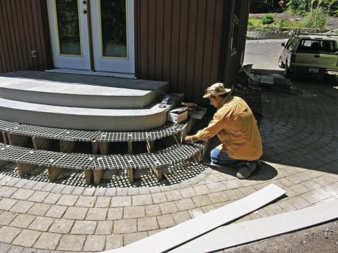  Cellular PVC trim was used to form the curved fascia trimming the stair risers. A heat gun was needed to warm up the trim and make it flexible enough to bend around the tight curves. When heating and bending PVC lumber, keep the gun moving to avoid blistering the trim.