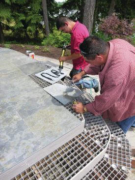 To ensure good adhesion, each slate tile was washed off with water, thoroughly dried with compressed air, and wiped down with denatured alcohol before glue application and installation. 