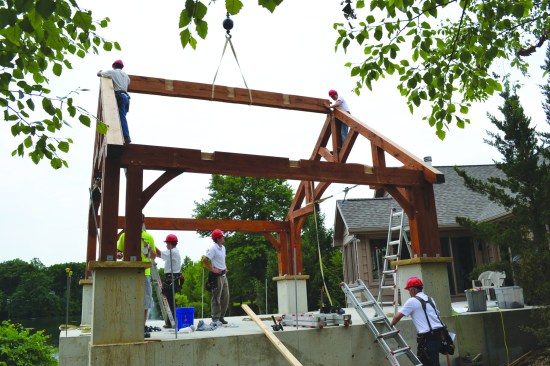 A 6x12 ridge beam ties the two end trusses together. For temporary protection, the pieces were coated with a water-based finish back at the woodshop.