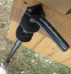 Figure 9. A cane bolt engages a pipe driven into the ground to secure the fixed half of the gate.