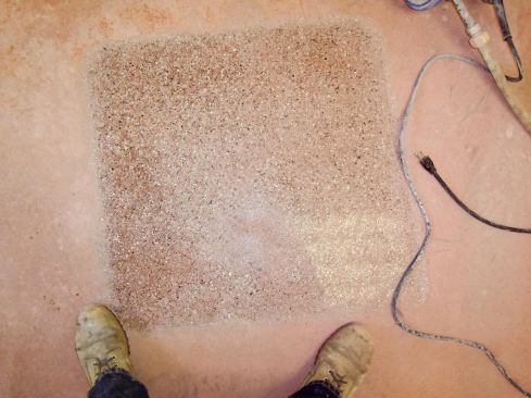 A couple of hours of work yielded a hard, smooth, brick-red finish with multicolored exposed aggregate that you could see your reflection in.