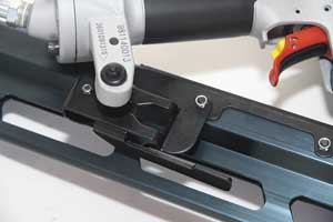 The thumbwheel on the nose of the Paslode (above) is typical of the depth-of-drive mechanisms found on most framing guns. The thumb-activated mechanisms on the DeWalt (right) and Bostitch guns are particularly easy to use.