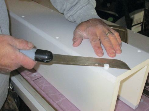 When all of the plugs are in, I go back and trim them flush, using a thin, flat saw. I sand the faces to smooth over the plugs and to remove any remaining saw marks. Finally, I caulk all the joints using 100% acrylic latex caulk. The wraps are now ready for paint.