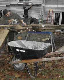 Figure 2. Setting up a wheelbarrow or garbage can for scraps at the cutting station is an easy and fast way to keep the site cleaner.