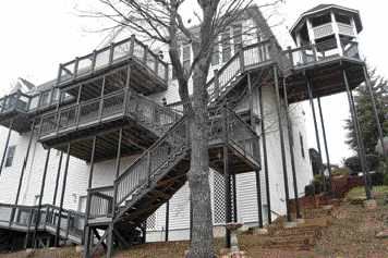 Figure 2. Bringing stairs off the end of the deck saves floor space. Very high decks require landings between levels. Having the stairs reach the ground close to the house, where the grade is highest, keeps them as short as possible.