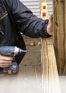 Figure 11. A nail placed in the side of the newel supports it while it's initially secured with LedgerLok screws. Later, the newel is shimmed plumb and secured with a DeckLok Bracket or a Simpson HD5.