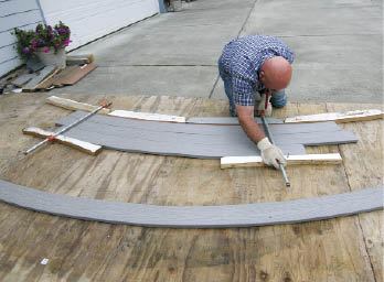 Figure 1. When building curved stairs, start with a full-scale layout on plywood. Use it as a template for bending tread stock and for noodling out dimensions.