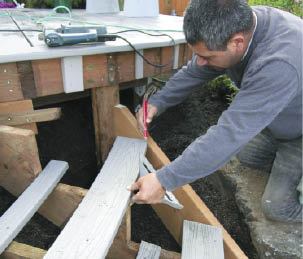 Figure 6. Verify the diagonal jack's location with a piece of bent decking or a plywood tread template.