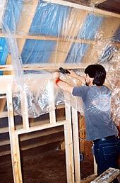 In the case shown, a kneewall complicated the vapor barrier installation (photo). To prevent that, the author recommends first insulating the entire roof plane down to the eaves, then building the kneewall.