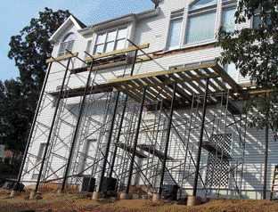 Figure 5. Scaffolding is essential to provide a safe and efficient workplace at a height. Be sure to rent enough to scaffold the sides and the width of the deck, and have extra walk boards to facilitate material handling.
