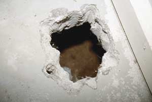 Figure 2. Once a vent opening through the slab has been made with a rotary hammer ( top), the fill beneath is dug out to create a sump (center). The finished sump is about a foot deep and as wide as a worker can reach by hand (bottom).