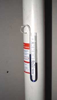 Figure 7. A vacuum monitor installed in the vent pipe confirms that the fan is providing the required negative pressure, although further testing is needed to determine whether indoor radon levels have actually declined.