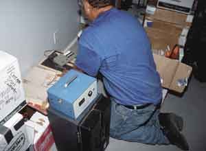 Figure 8. An electronic radon-monitoring device continually tests the amount of gas present. Once each hour, it prints out the current radon level as well as an average that factors in all previous readings.