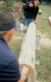 Figure 2. All layout on logs springs from a centerline. To find it, a plumb line is drawn through the center of each end of the log (top); the points where these lines intersect the face of the log are joined with a chalk line (above).