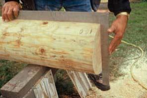 Figure 3. To mark the end of the log to be cut square to the centerline, a framing square is held to the layout line (top). It takes a little finesse to hold the pencil square to the square. After the cut, check for square (above), but remember to allow for any taper the log may have.