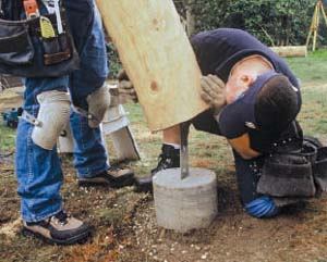 Figure 7. Placing the post is a two-person operation. Be sure the log is oriented correctly, and not 180 degrees off.