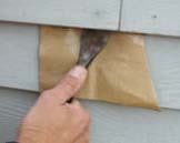 Figure 2. Careful prying near the face nail often lifts both the siding and the nail.