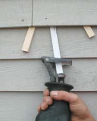 Figure 4. When prying doesn't free up the nail, putting wedges under the siding and using a metal- cutting blade will do the trick.
