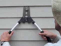 Figure 11. Thin-bladed nail cutters slide under a course of siding to snip the fasteners.