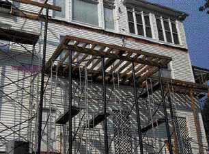 Figure 10. Bracing the beams on steel columns is done first with temporary 2x4s tied to the ledger, then more permanently using joists.