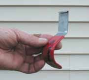 Figure 14. A J-shaped zip-lock tool (top) grabs the bottom lip of vinyl siding, disengaging it from the course below (above).