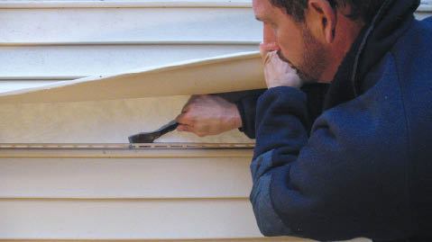 Figure 15. With the upper piece exposed, vinyl siding's fasteners are easily accessed.