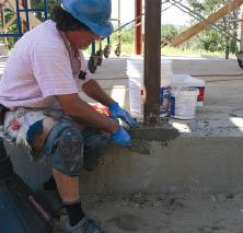 The top nuts rigidly hold the columns in place. After the complete frame is assembled, the author packs the voids under the plates with fast-setting hydraulic cement.