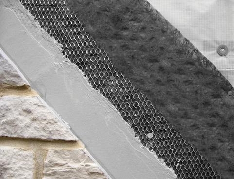 The scratch coat adheres to the fabric and metal lath and is stopped from entering the matrix by the fabric.