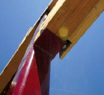 Where an LVL header meets the steel post, the author welded 3-inch-deep bearing plates to support the beam. Though the LVL adds no structural strength to the frame, it matches the column thickness and provides stiff backing for the finish trim.