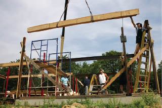 Working with a 68-foot boom, the crew set the first-floor perimeter beams in one long day. Installing the wood cladding while the steel was still at the shop saved plenty of on-site labor.
