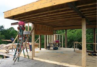 Three projecting steel beams support the wood I-joist framing in this 7-foot-deep roof overhang.
