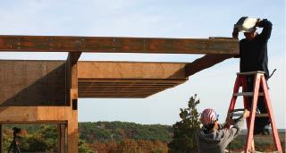 A cantilevered shading trellis projects from the western face of the house.

