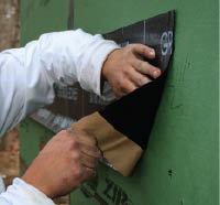 Figure 3. The first step in the ledger flashing sequence is to apply peel-and-stick membrane directly to the sheathing where the ledger will go, as shown above. The peel and stick is wide enough to extend above and below the ledger. After the siding is installed, the release film along the bottom will be removed so the peel and stick can be adhered to the face of the siding.