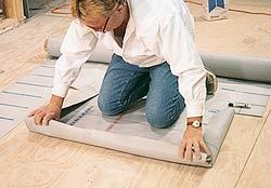 The entire sheet is rolled up and placed on the sloping mortar subfloor.