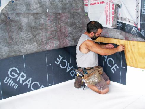 Peel-and-stick membrane flashing adhered to the sheathing serves as a counterflashing. It will later be covered with housewrap.