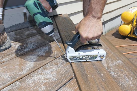 We use the Camo Hidden Deck Fastening System for borders and inlays; it consists of an installation jig and proprietary self-drilling screws that toenail through the edge of the deck board.