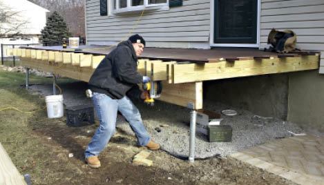 Figure 13. Because helical piles' load capacity can be verified,  it's often possible to use fewer footings and a larger support beam. In this case, the span between piles is over 15 feet.Photo credit: Greg DiBernardo