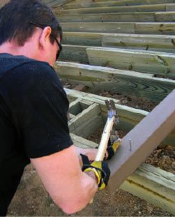 Figure 4. Nails driven partway into the post will support it at the correct height on the housing. This makes it easy for one person to plumb, shim, and bolt the post home.