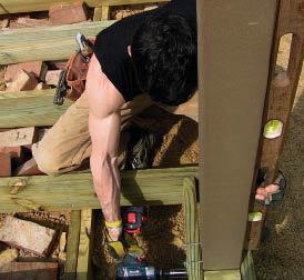 Figure 6. Use a cordless impact driver to quickly cinch down the bolts. LedgerLok screws are an alternative to bolts for wood posts, subject to local approval.